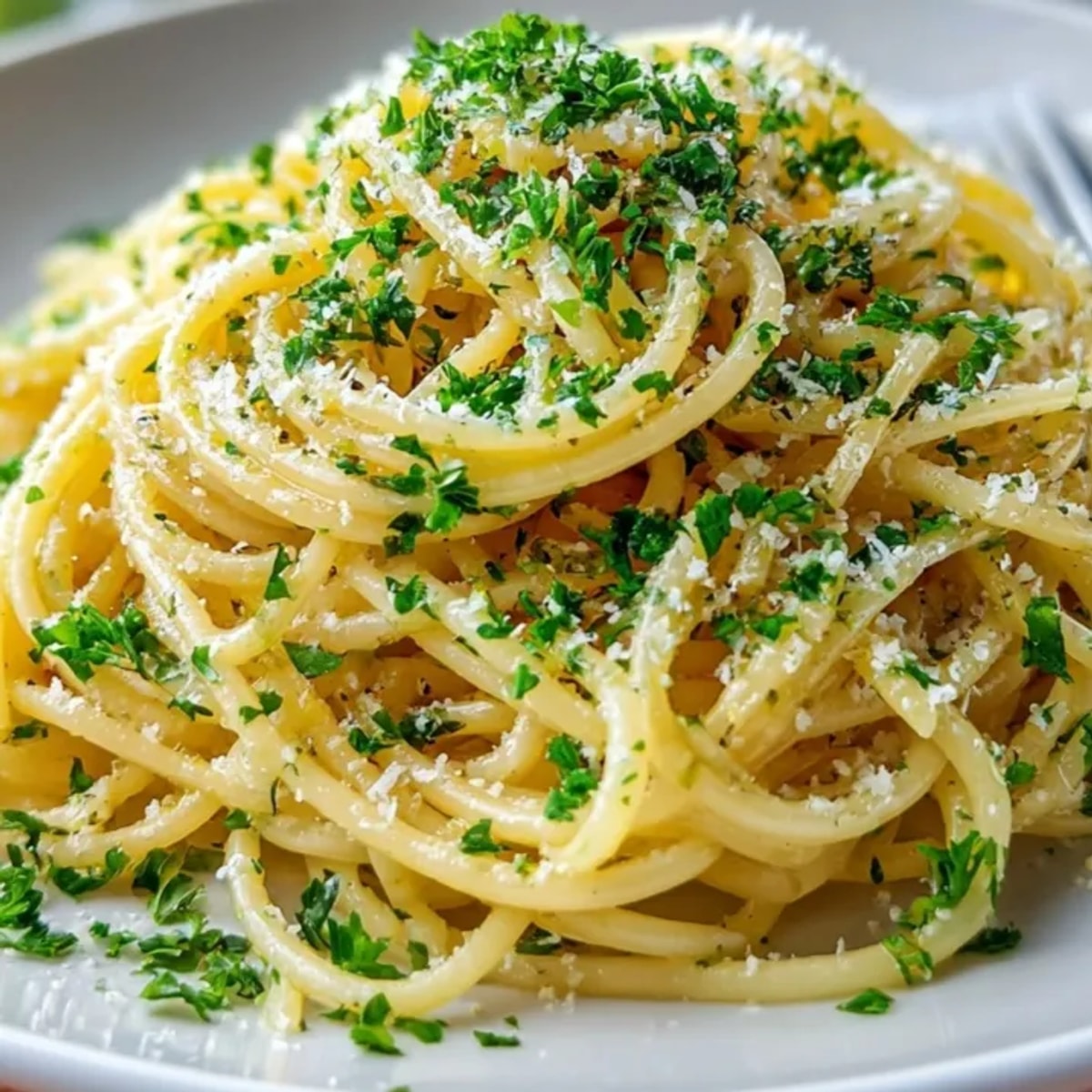 Creamy Garlic Butter Pasta with Parmesan garnished with fresh parsley – a simple Italian delight.