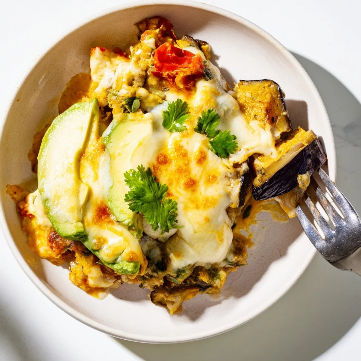 Oven-baked Avocado Eggplant Curry Bake serving suggestion with warm naan and fresh herbs.