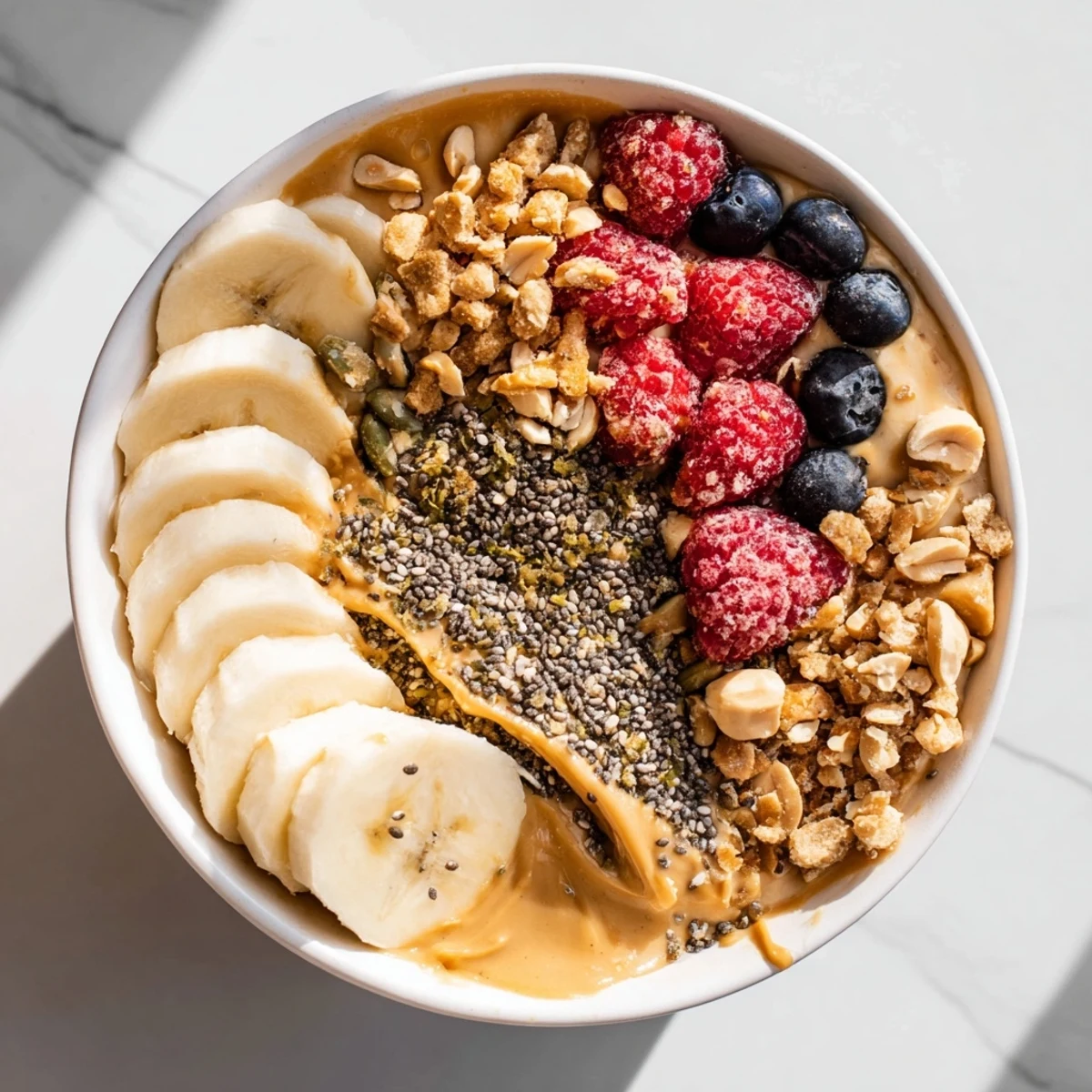 Delicious Protein Peanut Butter Breakfast Bowl drizzled with honey and crunchy granola.
