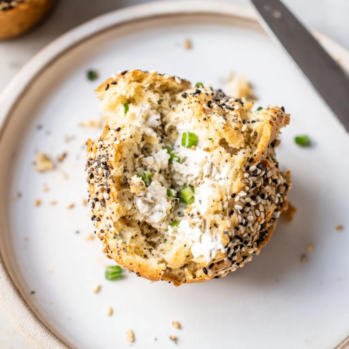 Fluffy cream cheese everything bagel muffins topped with savory seasoning, perfect for brunch.
