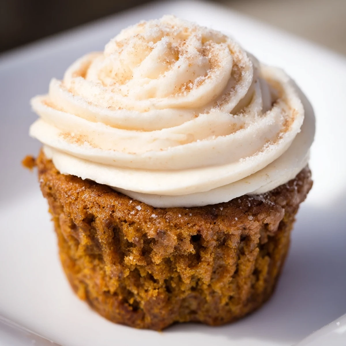 Deliciously spiced root beer pumpkin cupcakes garnished with cinnamon for the ideal autumn dessert.
