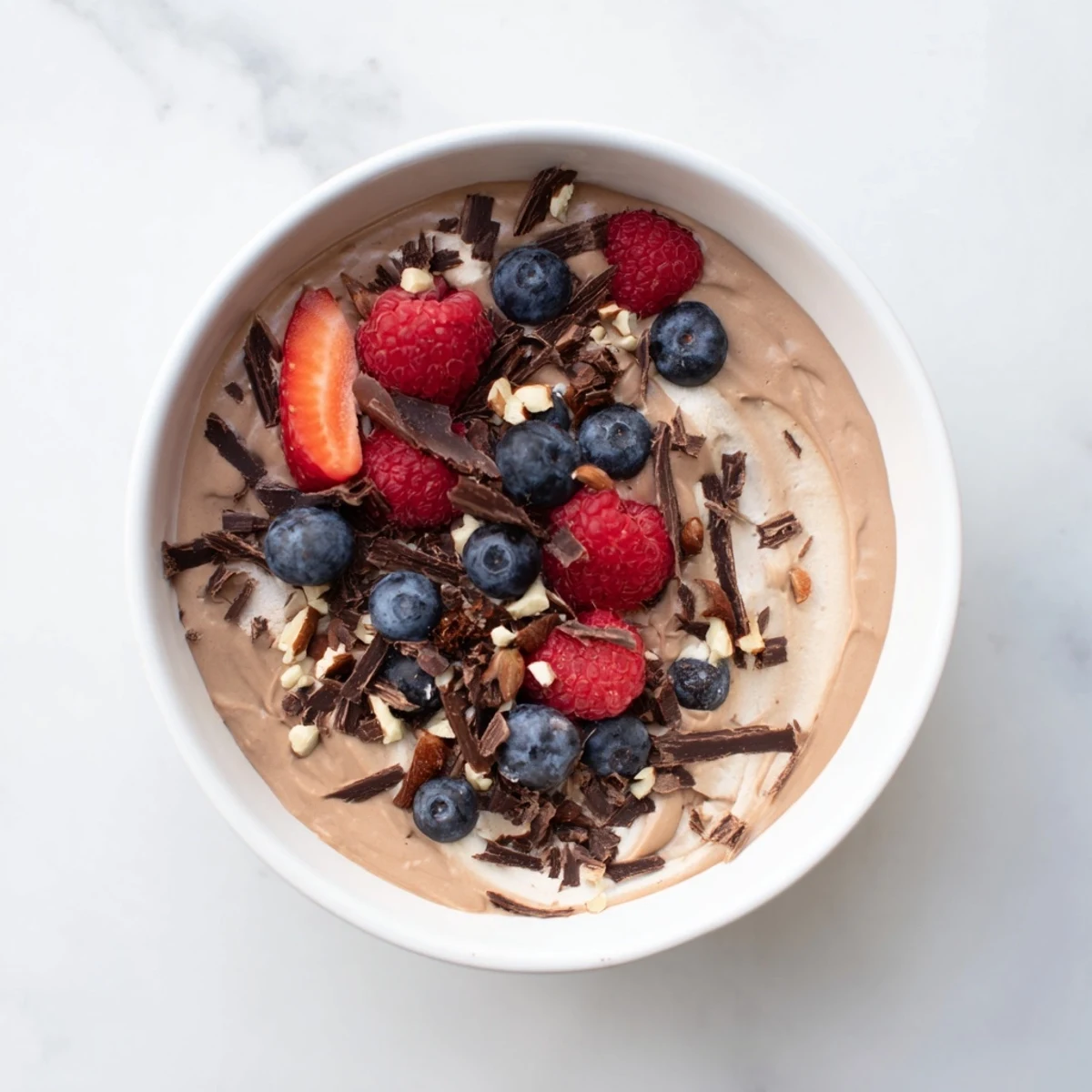 Silky smooth No-Bake Cottage Cheese Chocolate Mousse, swirled with melted chocolate and fresh berries.