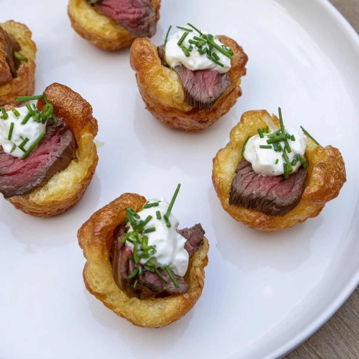 Golden-brown Express Holiday Yorkshire Pudding Bites, filled with tender roast beef & horseradish cream; ready to enjoy.