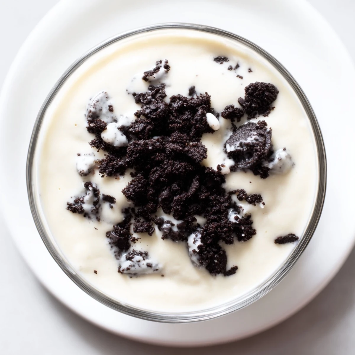 Enjoy a spoonful of vanilla pudding and Oreos, a classic dessert with pleasing textures and flavors.