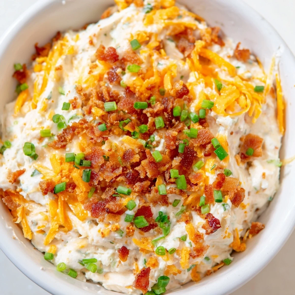A bubbly, golden brown cheesy bacon ranch dip, perfect for dipping tortilla chips or veggies.