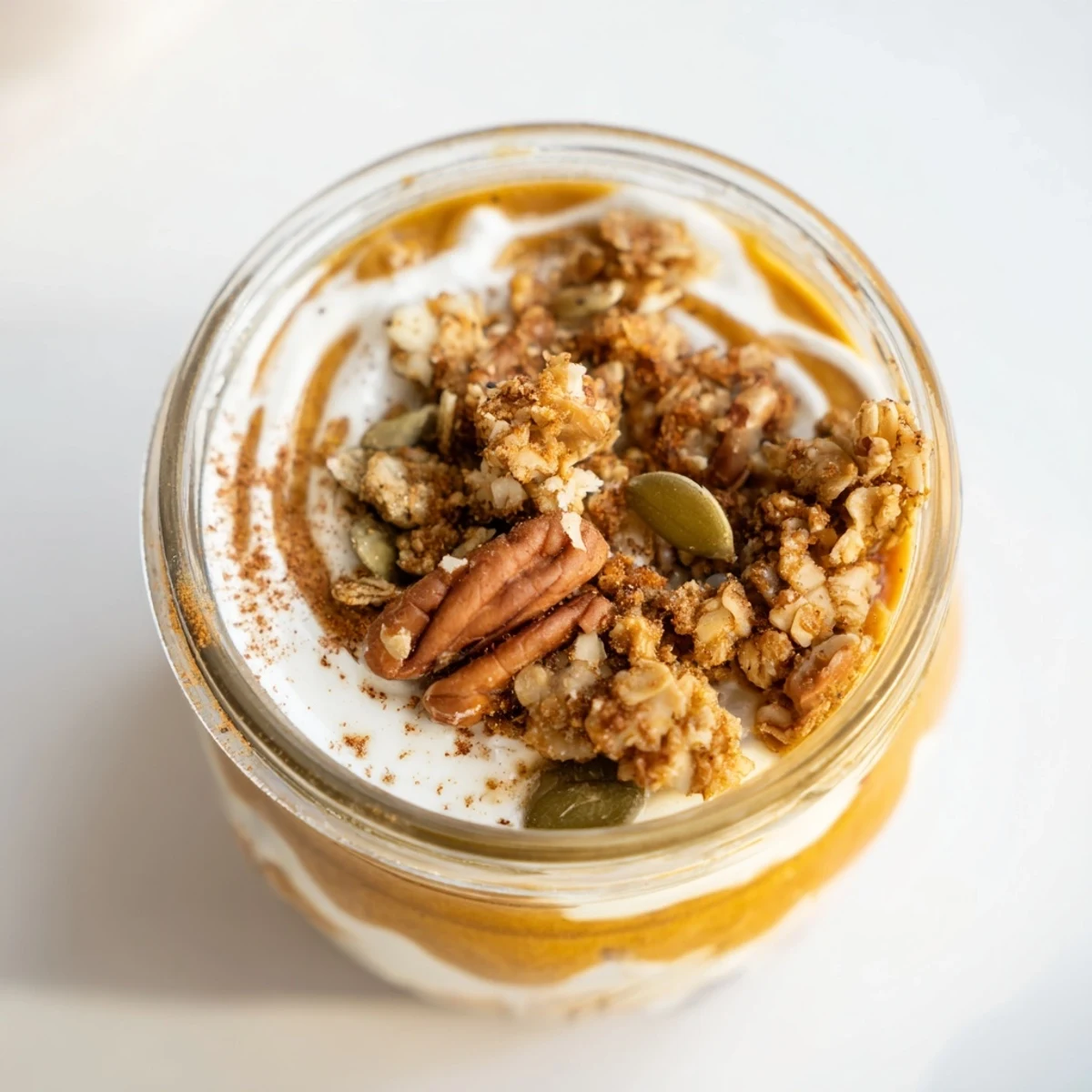A visually appealing Pumpkin Yogurt Parfait, perfect for a quick, healthy autumn snack or dessert.