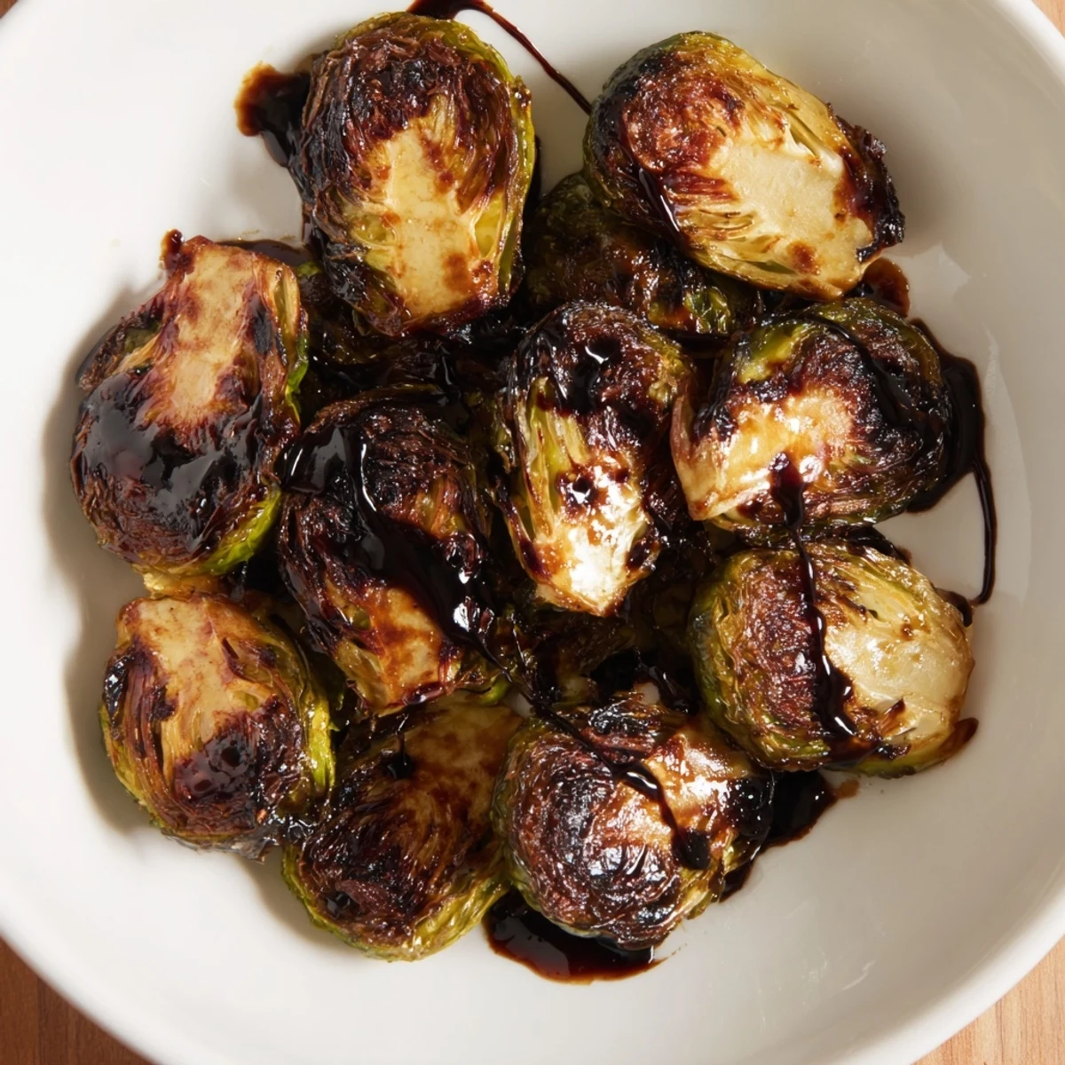 Savory Roasted Brussels Sprouts with Balsamic drizzle, served warm as a perfect vegetarian side dish.