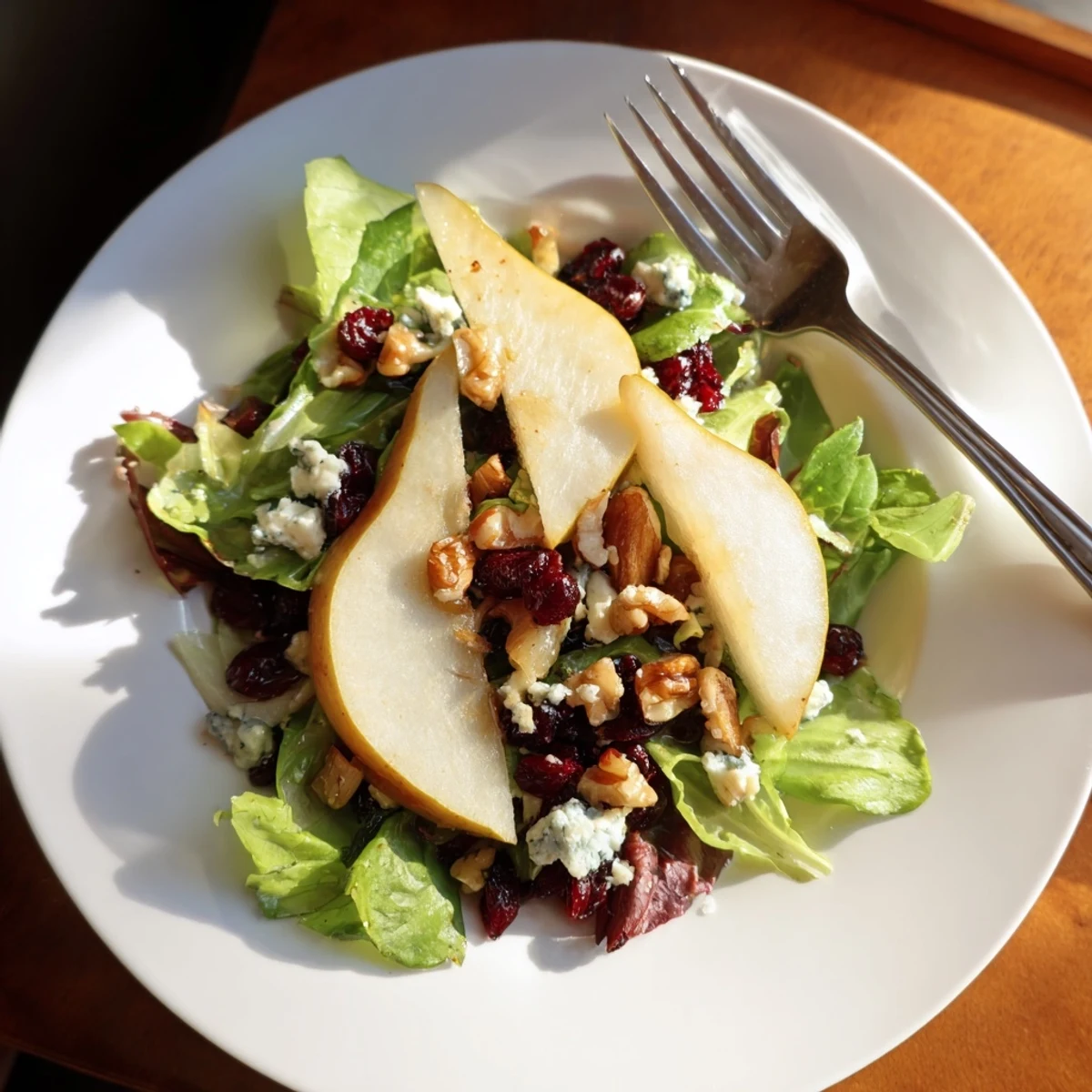 Freshly sliced ripe pears and crumbled Gorgonzola cheese atop a bed of mixed greens with toasted walnuts, drizzled with honey-balsamic vinaigrette.
