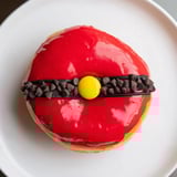 These vibrant Santa Belly Donuts show a rich red glaze with chocolate belt and yellow buckle.