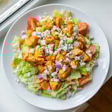 A colorful bowl of Buffalo Chicken Chopped Salad features crisp romaine and crunchy celery.