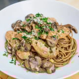 A visually appealing plate of creamy mushroom chicken spaghettini, garnished with fresh parsley and Parmesan cheese.