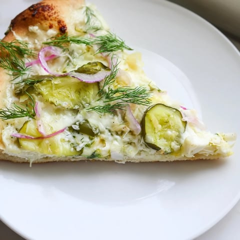 Tangy Pickle Pizza with creamy sauce and melted mozzarella, perfect for adventurous eaters.  