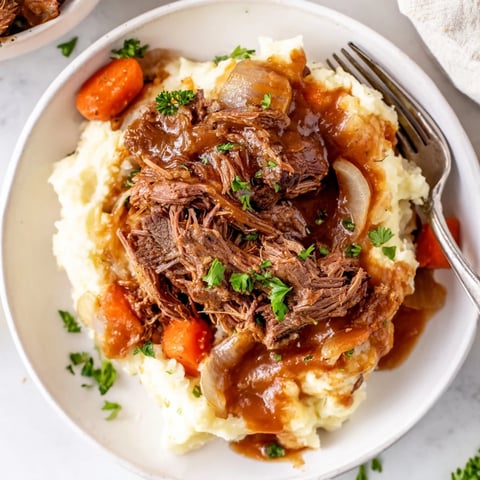 Slow Cooker Pot Roast with Mashed Potatoes served with savory vegetables and rich gravy.