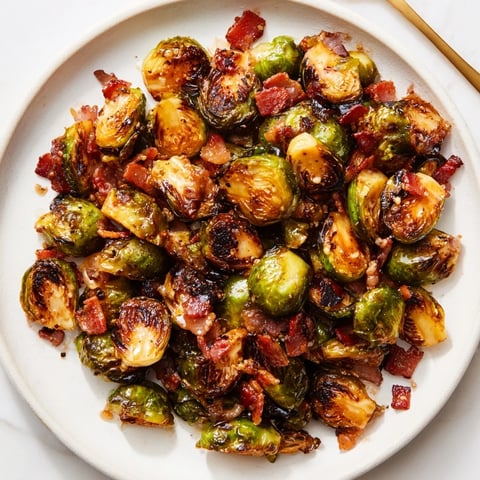 Crispy Maple Bacon Brussels Sprouts drizzled with sweet maple glaze, perfect for sharing.  
