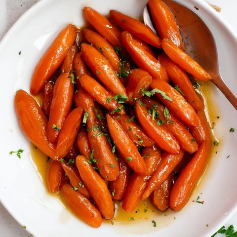 Tender bourbon maple glazed baby carrots, a sweet and savory side dish.  
