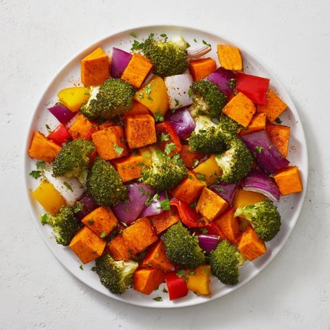 Friendsgiving Rainbow Roasted Vegetable Medley with glistening, caramelized edges, arranged on a platter.
