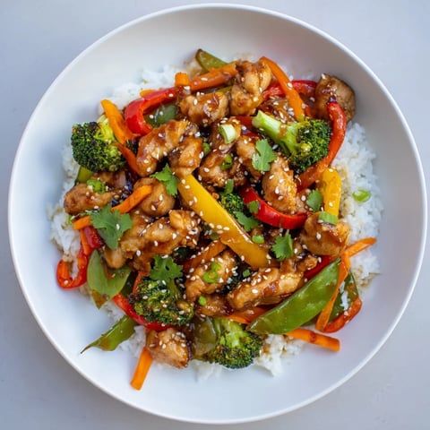 Sizzling Chicken Stir-Fry with bright vegetables and fluffy rice, ready for a delicious dinner.