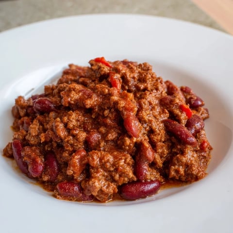A steaming bowl of The Secret 4-Ingredient Slow Cooker Chili Dump, ready for your favorite toppings.
