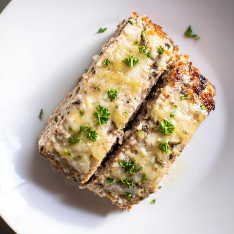 Golden brown Juicy Garlic Parmesan Chicken Meatloaf, glazed and ready to slice for dinner.