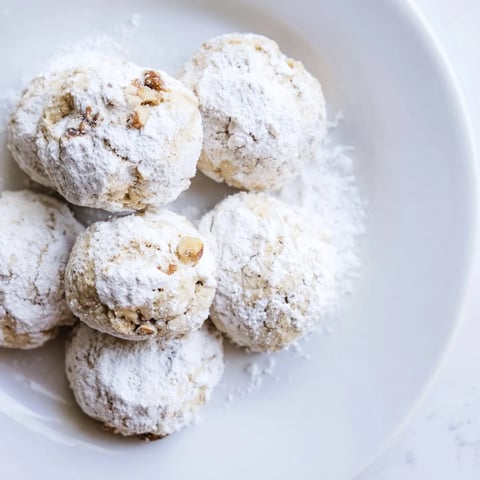 Golden, buttery Budget-Friendly Snowball Cookies, ready to enjoy with a warm cup of coffee and friends.