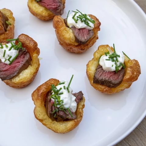 Golden-brown Express Holiday Yorkshire Pudding Bites, filled with tender roast beef & horseradish cream; ready to enjoy.