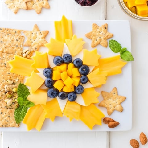 Shooting Star Snack Board with vibrant fruits, cheeses, and crackers; perfect party appetizer.