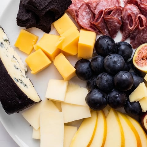 Elegant Celestial Night Board overflowing with cheeses, charcuterie, fruits, and star-shaped chocolates.