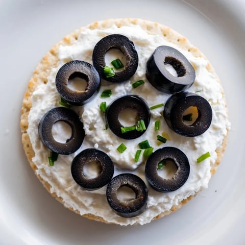 Golden Medal Olympic Ring Appetizers are vibrant, colorful crackers with cream cheese and assorted toppings.