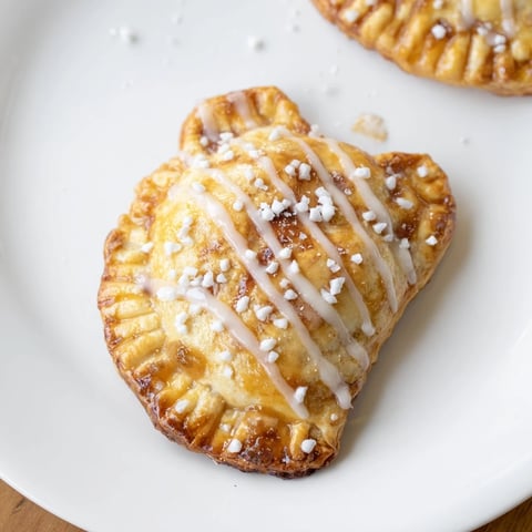 Warm, golden Winter Comfort Mitten Shaped Hand Pies, filled with spiced apples, ready for serving.