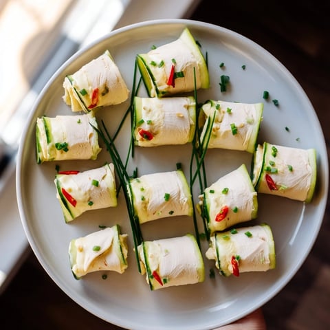 Stacked turkey roll-ups, vibrant with red peppers and cool cucumber, ready for a healthy appetizer.