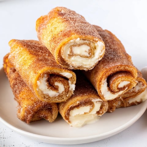 Golden, crispy Easy French Toast Roll-Ups, dusted in cinnamon sugar, perfect for a quick breakfast.
