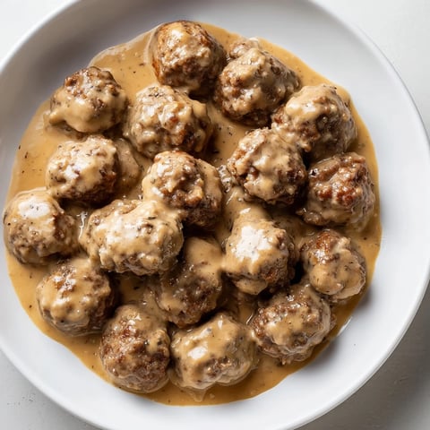 Creamy Swedish Meatballs, served with mashed potatoes, offering a comforting, savory aroma for dinner.
