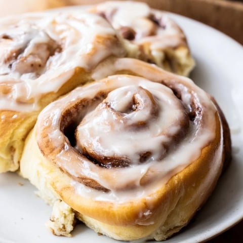 Fluffy Pillow Soft Cinnamon Rolls fresh from the oven, glistening with creamy glaze and ready to enjoy.