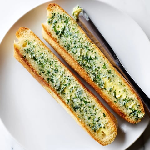 Golden, crusty Herb Butter Toast with melted butter, herbs, and a sprinkle of flaky sea salt.