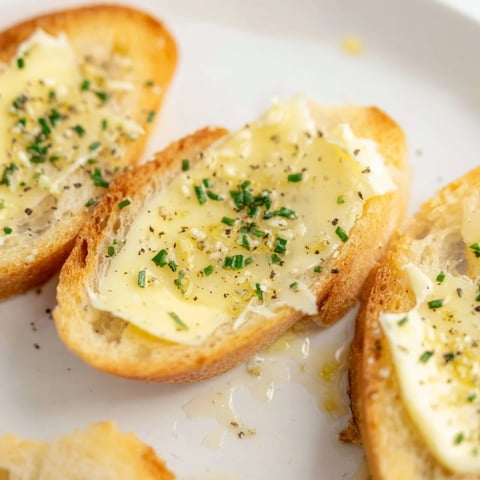 Crisp golden Vodka Butter Crostini, ready to serve and topped with creamy, seasoned butter.
