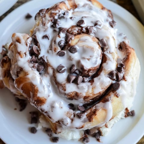 Warm, glistening Nutella Chocolate Chip Rolls, freshly baked with a sweet, chocolatey aroma ready to enjoy.