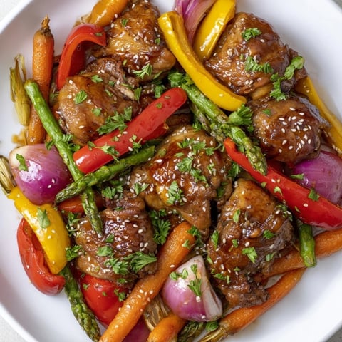 Sheet Pan Honey Garlic Chicken & Veg, a colorful array of roasted chicken and vibrantly glazed vegetables.