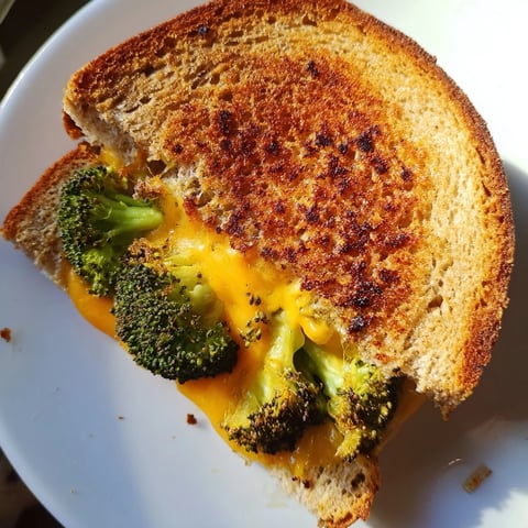 Golden, melty Roasted Broccoli & Cheddar Grilled Cheese, showcasing crispy bread and perfectly roasted broccoli.