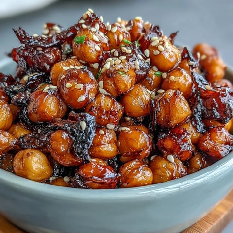 Crispy chili garlic chickpeas served over fluffy jasmine rice in a vibrant vegan bowl.  