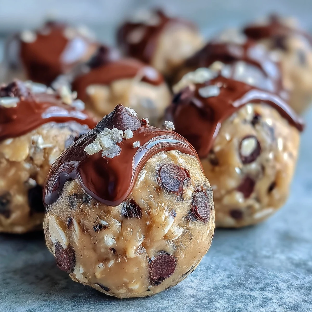 High-protein cookie dough bites made with oats, almond butter, and chocolate chips for a healthy snack.  