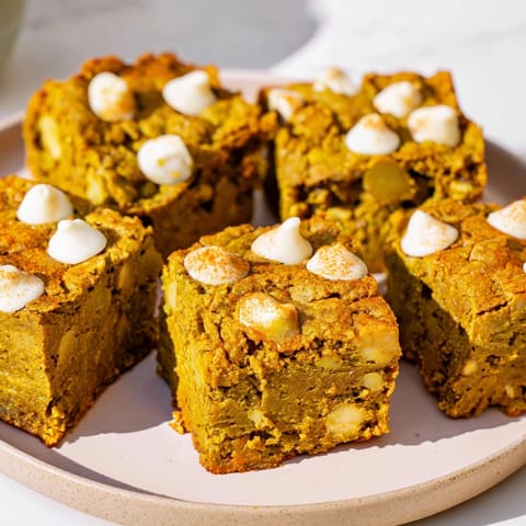Earthy green Matcha Pumpkin Muffin Blondies, a vibrant autumn dessert sliced and ready to serve.