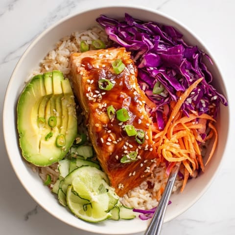 Colorful soy-maple salmon rice bowls featuring fluffy rice and vibrant veggies.  