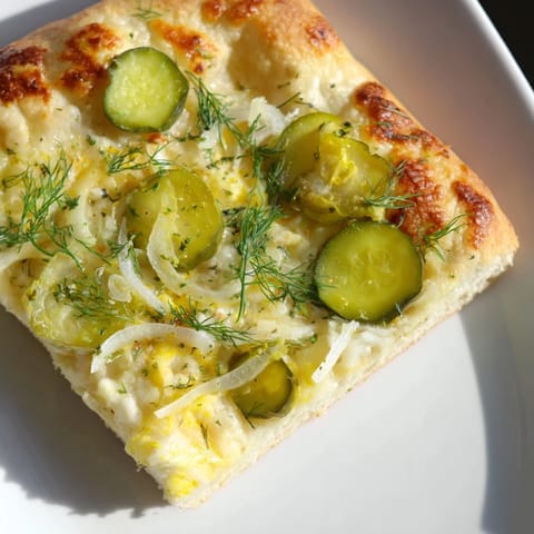Delicious Pickle Pizza topped with crunchy dill pickles, ideal for a unique dinner.  