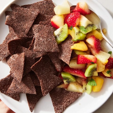 Homemade dessert chips & salsa showcasing vibrant fruits and rich chocolate flavors.  