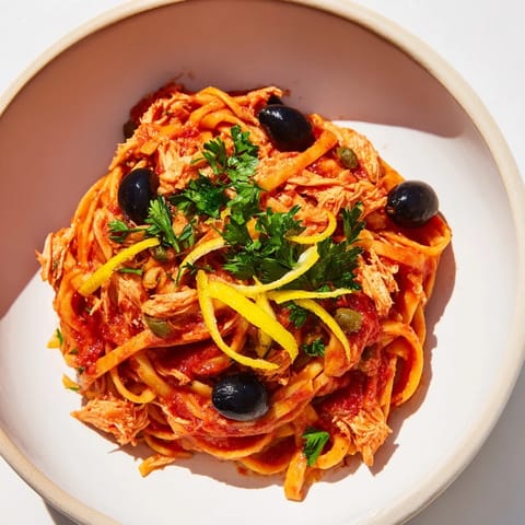 This Pasta with Tuna, Olives & Capers boasts bright, juicy tomatoes and flaky tuna atop perfectly cooked spaghetti.