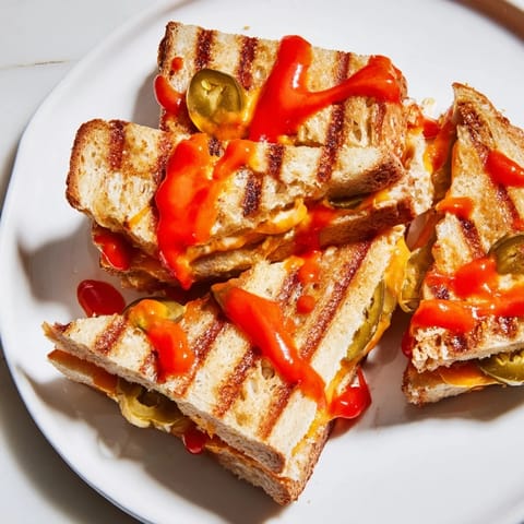 Mouthwatering image of Spicy Pickle Grilled Cheese Dippers, featuring warm, cheesy goodness and a spicy kick.