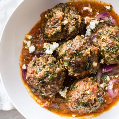A close-up of delicious Instant Pot Greek Meatballs, showcasing their juicy texture and bright lemon-feta.