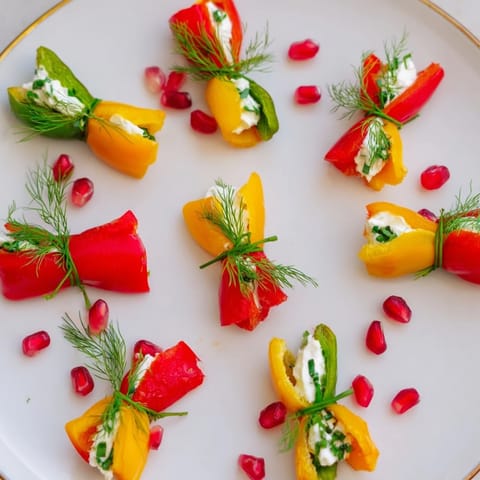 A close-up of festive Bell Pepper Christmas Bows, displaying the bright colors and creamy filling, perfect for entertaining.