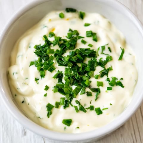 Homemade Veggie Ranch Dip, featuring fresh herbs, ready for dipping crisp, colorful carrot sticks.