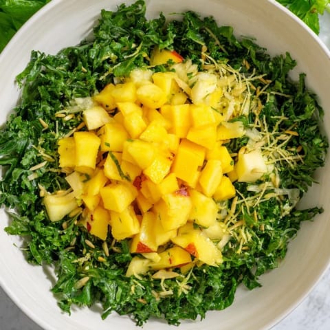 Fresh The Sunlit Glade salad showcases bright mango, pineapple, and greens, sprinkled with toasted seeds.